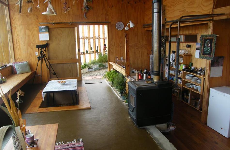 The main living area  looks out to the conservatory, with the wood-burning stove, kitchen and...