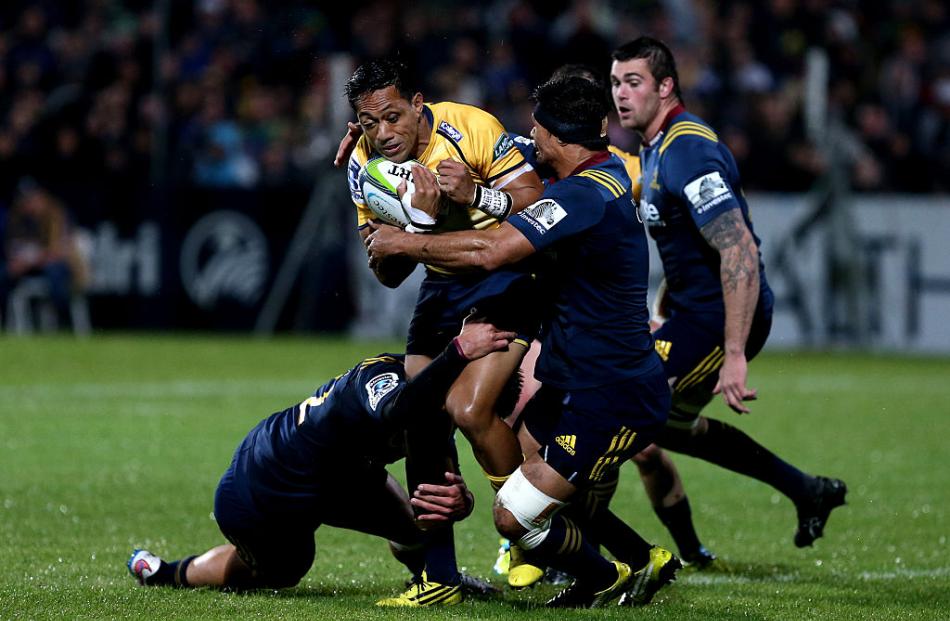 Highlanders' players tackle Christian Lealifano of the Brumbies. Photo: Getty Images