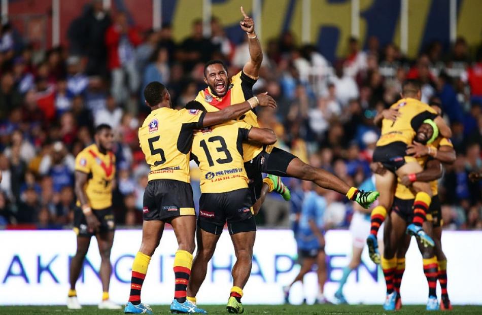Papua New Guinea players celebrate after beating Fiji. Photo: Getty Images