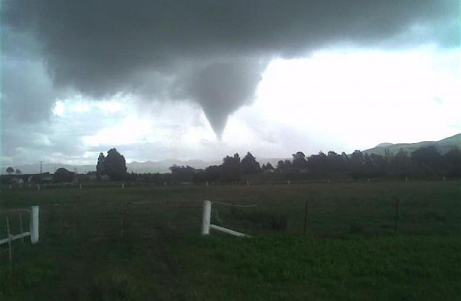 A tornado approaches the southern outskirts of Waikouaiti shortly after noon on Saturday. Photo...