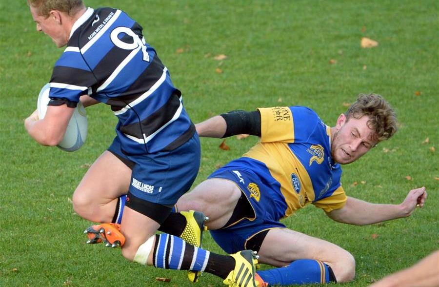 Kaikorai halfback Josh Renton is foot-tripped by Taieri fullback Mitchell Scott at Bishopscourt...