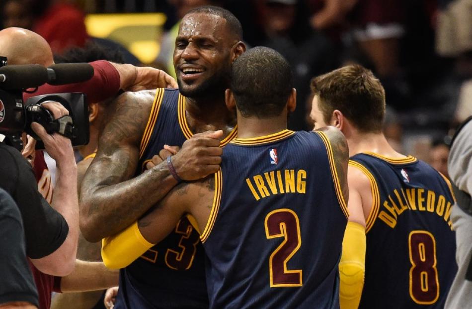 LeBron James and Kyrie Irving celebrate after advancing to the conference finals. Photo: Reuters