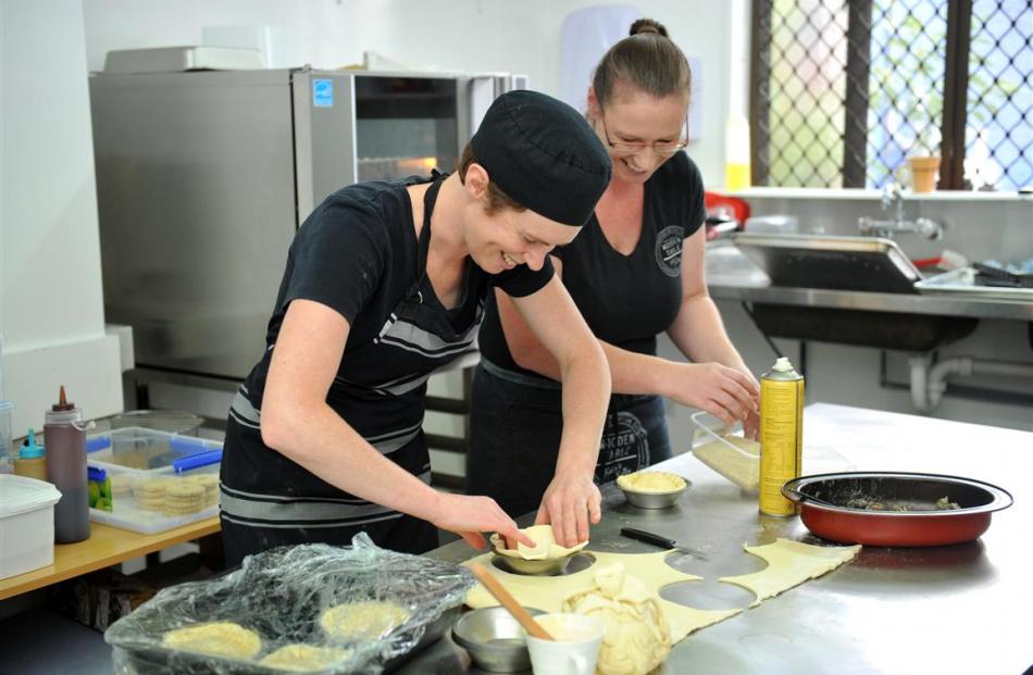 Kate Woodhouse (left) and Kelly Ennis prepare pies in the kitchen of their new business. Photo:...