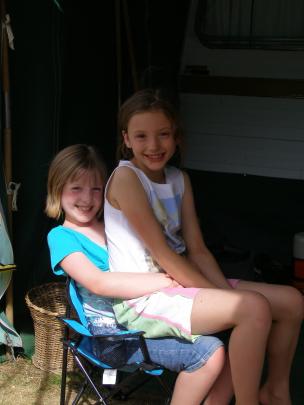 Camp friends . . . Hannah White (8), left, and Abbey Hamilton (8) catch up at Pleasant Point Camp...
