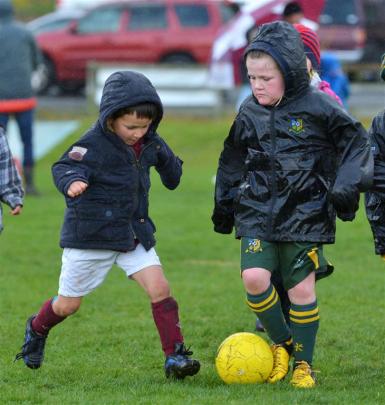 Mateo Mirosa (5, left), of Maori Hill Maroons, and Ella Bezett (6), of Green Island Totaras,...