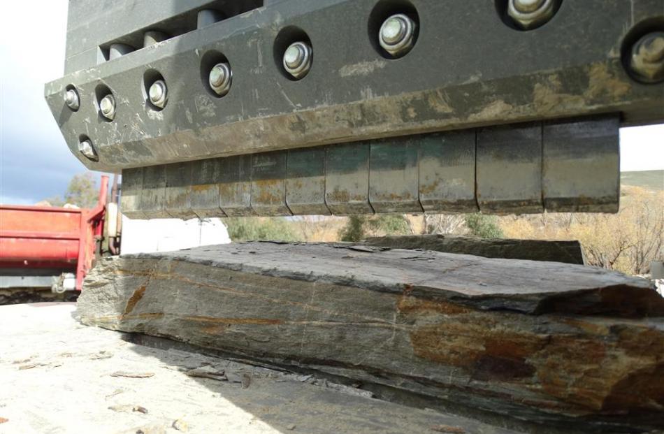 The  stone-cutting guillotine shows its tungsten-capped teeth.