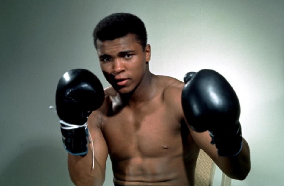 A young Muhammad Ali poses with his gloves up. Photo: Reuters