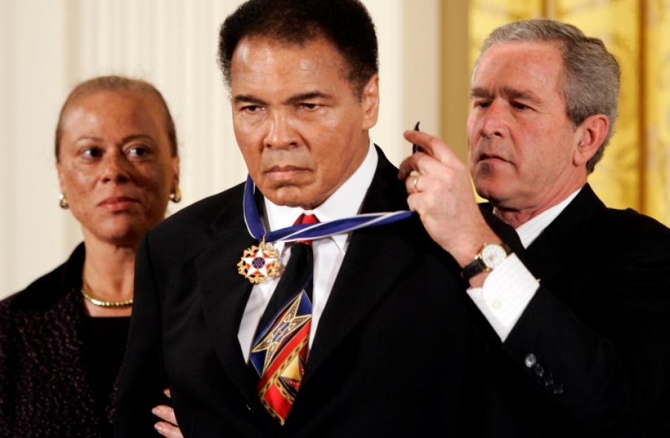 Former US President Bush awarding boxing legend Muhammad Ali with the Presidential Medal of...