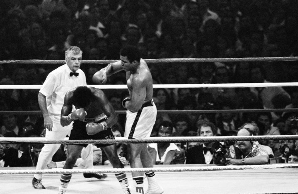 Muhammad Ali (R) drops an overhand right on Leon Spinks during their second match at the...