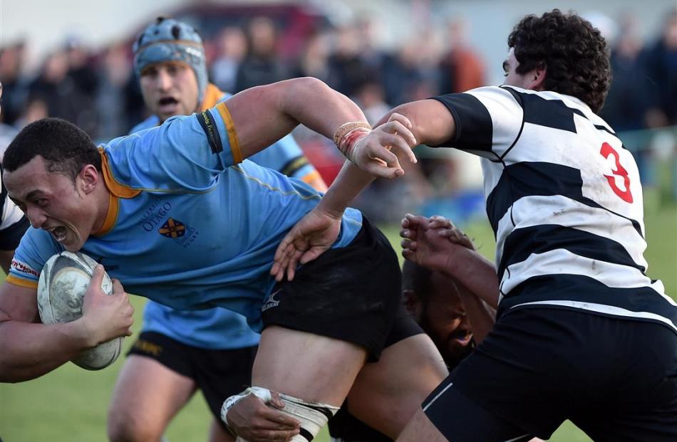 University A No8 Sione Teu charges past Southern prop Tom Scalan during their  Dunedin premier...