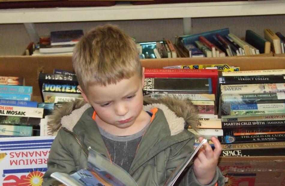 Richie Shaw (5), of Cromwell, studies a book based on the movie Cars.