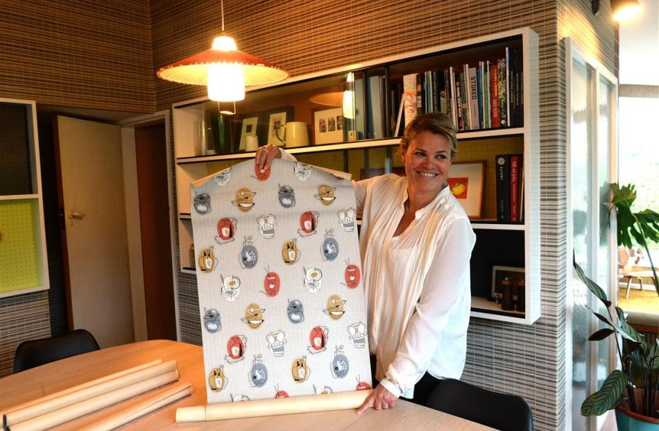 Heidi Hayward with one of the rolls of vintage wallpaper that she found in a cupboard, none of...