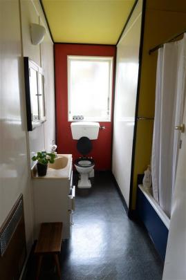 The bathroom paint scheme is a nod to De Stijl, the Dutch art movement in which everything was...