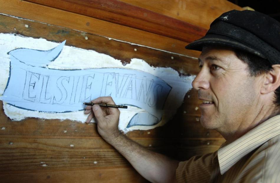 Otago Harbour Ferry Inc  chairman Shem Sutherland prepares sign writing on Elsie Evans in 2008.