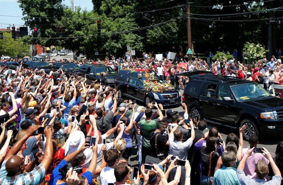 A hearse carrying the body of the late Muhammad Ali enters Cave Hill Cemetery in Louisville....