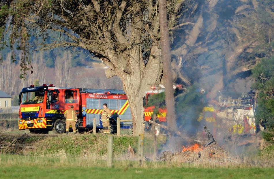 Fire crews attend a fire in Nichols Rd, near Momona, yesterday. PHOTO: STEPHEN JAQUIERY