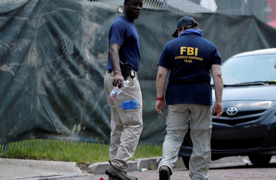 FBI investigators at the crime scene. Photo: Reuters