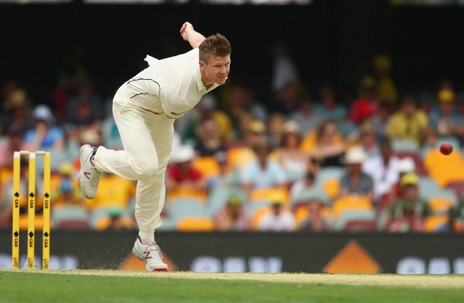 Jimmy Neesham bowls for New Zealand during their test against Australia at the Gabba last year....