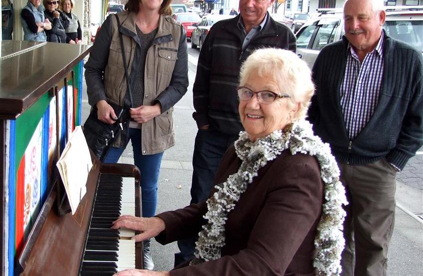 Alexandra musician Valerie Anderson plays for shoppers, watched by (from left) Yvonne Tohill, of...