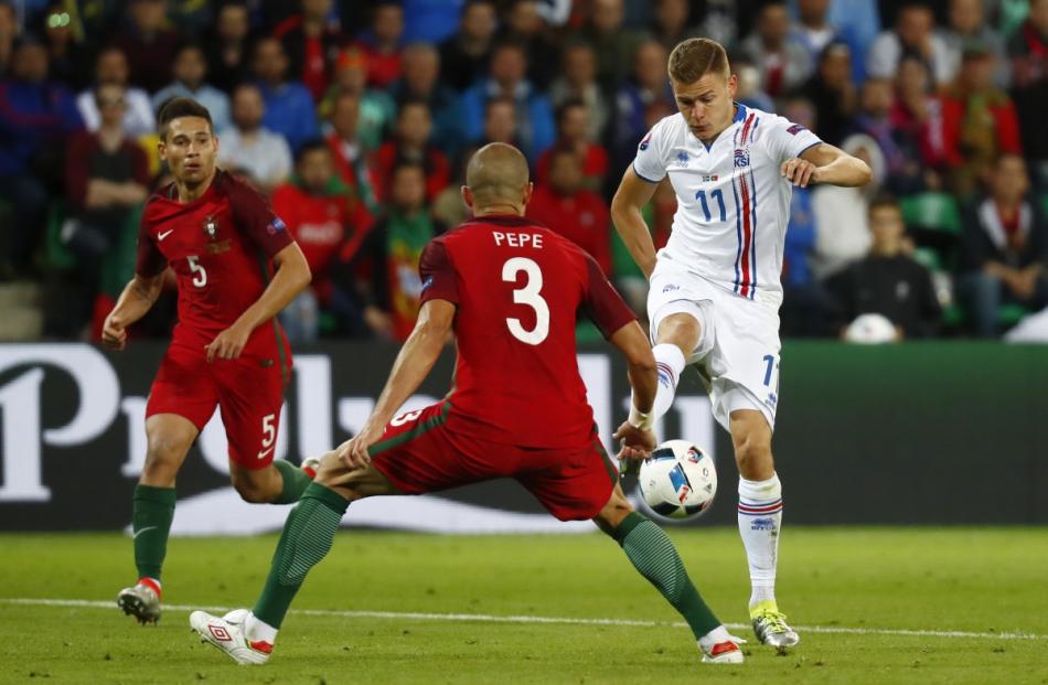 Iceland's Alfred Finnbogason shoots at goal during a match against Portugal at Stade Geoffroy...