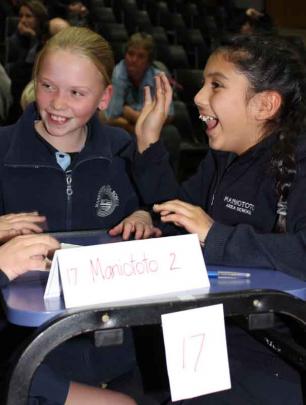 Maniototo School team members Jasmine Balloch (10) and Abby Ferdinands (9) chant their team...