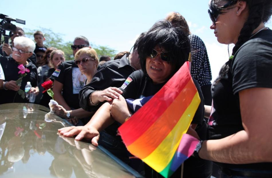 Lucyvette Padro touches the casket of her son Angel Candelario. Photo: Reuters