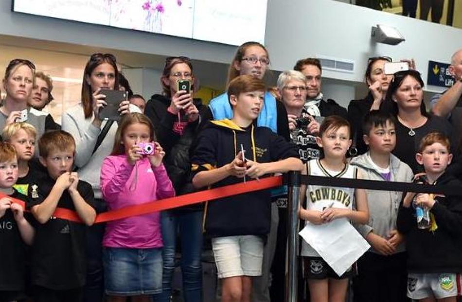 A crowd turned out at Dunedin Airport to welcome the All Blacks to the city.