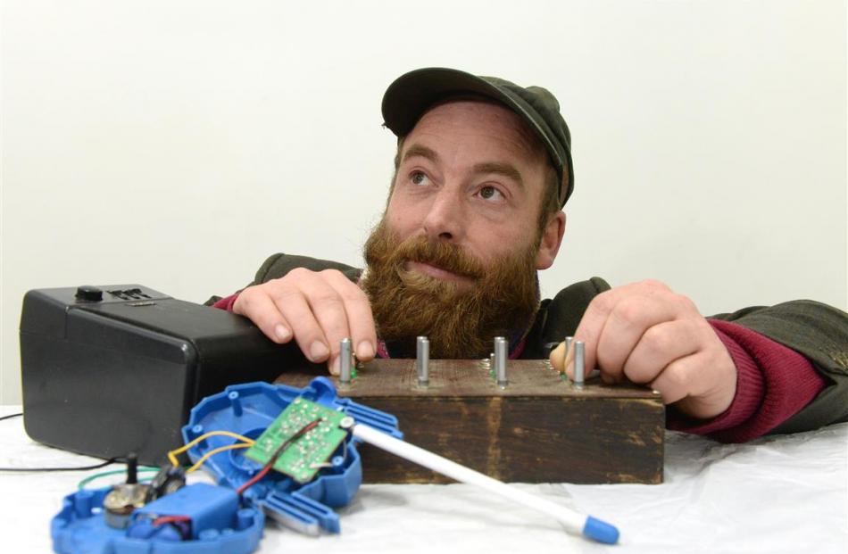 Sound artist William Henry Meung, with a hand-built oscillator box and a toy Transformer walkie...
