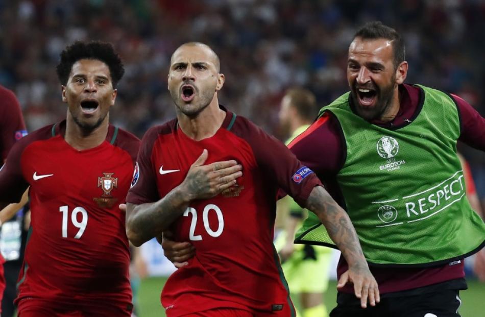 Ricardo Quaresma celebrates with team mates after winning the penalty shootout. Photo: Reuters
