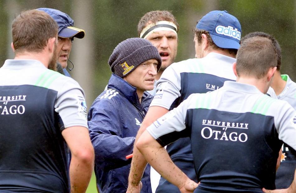 Assistant coach Tony Brown explains a move during training at Logan Park. Photos by Linda...