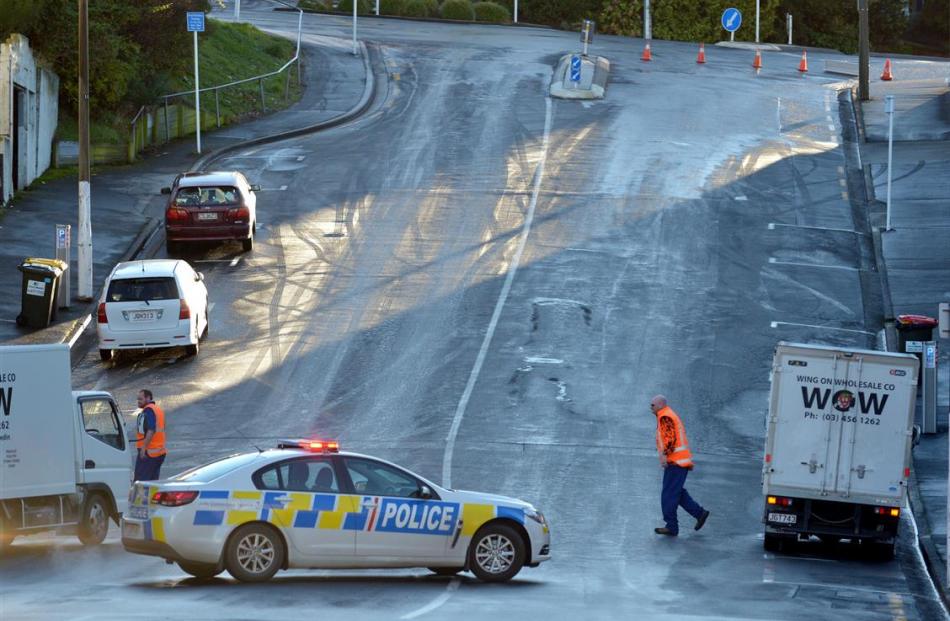 Police block Filleul  St between London and Hanover Sts yesterday morning after a hard frost made...