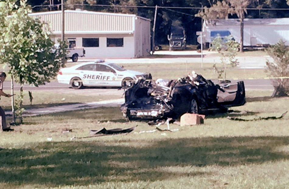 The Tesla Model S involved in the fatal crash on May 7 is shown with the top third of the car...