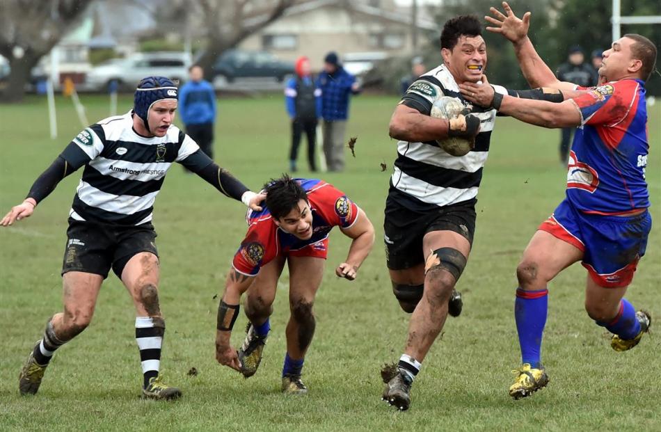 Southern No 8 Mika Mafi fends off Harbour loose forward Iloa Lihau at Bathgate Park on Saturday...