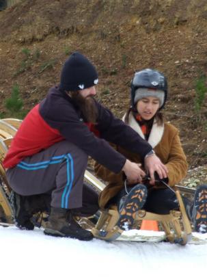 Luge coach Adam Jedrzejko,  of Poland, gives some pointers to luge first-timer Daisy Power. It is...
