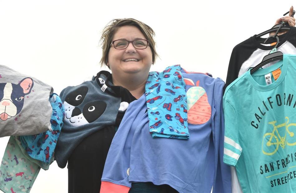 Foster Hope co-ordinator Juanita Willems holds a range of pyjamas donated  for foster children in...