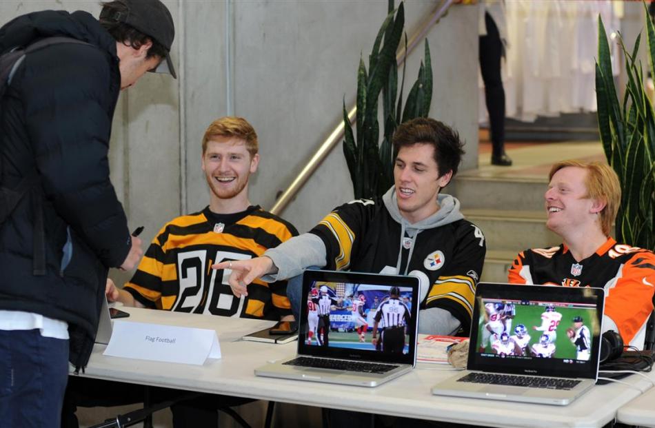 Signing up for flag football yesterday is Alex Smaill (22), of Dunedin. Manning the counter are ...