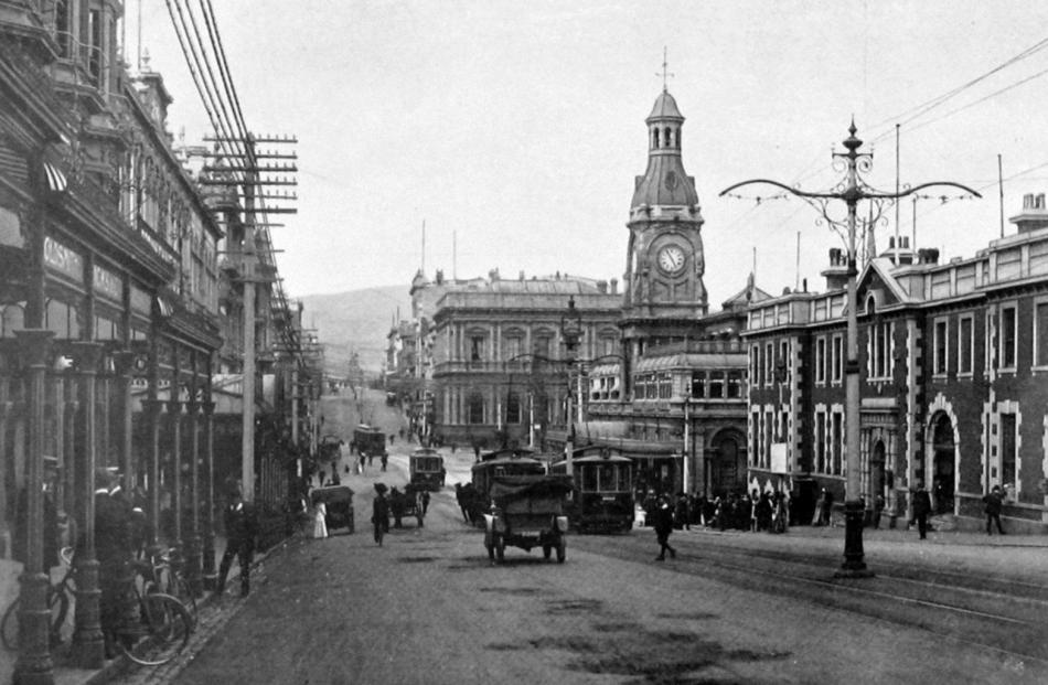 Electric trams, cars, bicycles and pedestrians share Princes St in the Exchange.