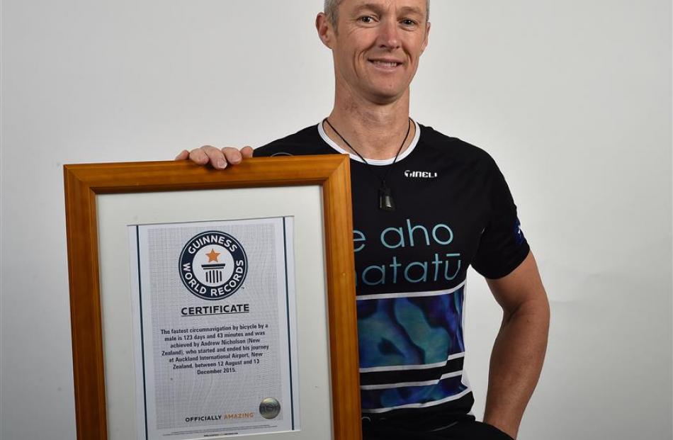 Dunedin cyclist Andrew Nicholson (45) holds his Guinness World Records certificate for being the...