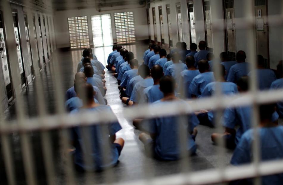 Inmates sit on the floor during an inspection visit in Klong Prem high-security prison in Bangkok...