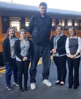 NBA superstar Yao Ming with Dunedin Railways staff (from left) Claire Anderson, Caitlyn Olsen,...