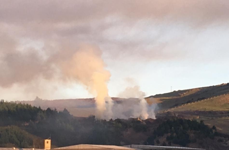 Smoke rises from a fire in a greenwaste pit at Burnside in Dunedin this morning. The fire has...