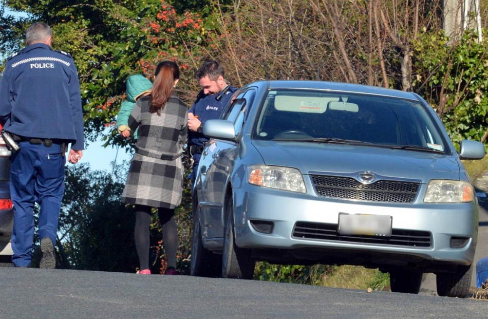 Police interview a woman who was verbally abused in a road rage incident in Queen St, Dunedin,...