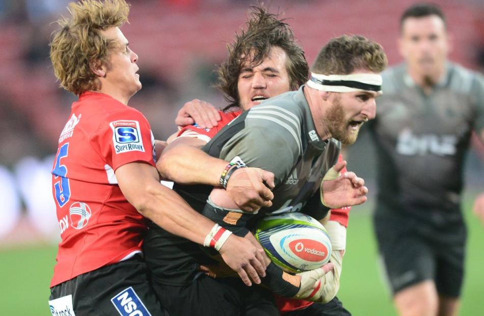 Kieran Read of the Crusaders tackled by Andries Coetzee of the Lions during the Super Rugby match...