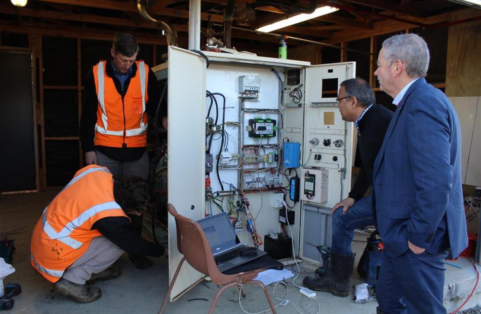 Inspecting the generator converting dairy effluent methane into electricity on a Southland dairy...