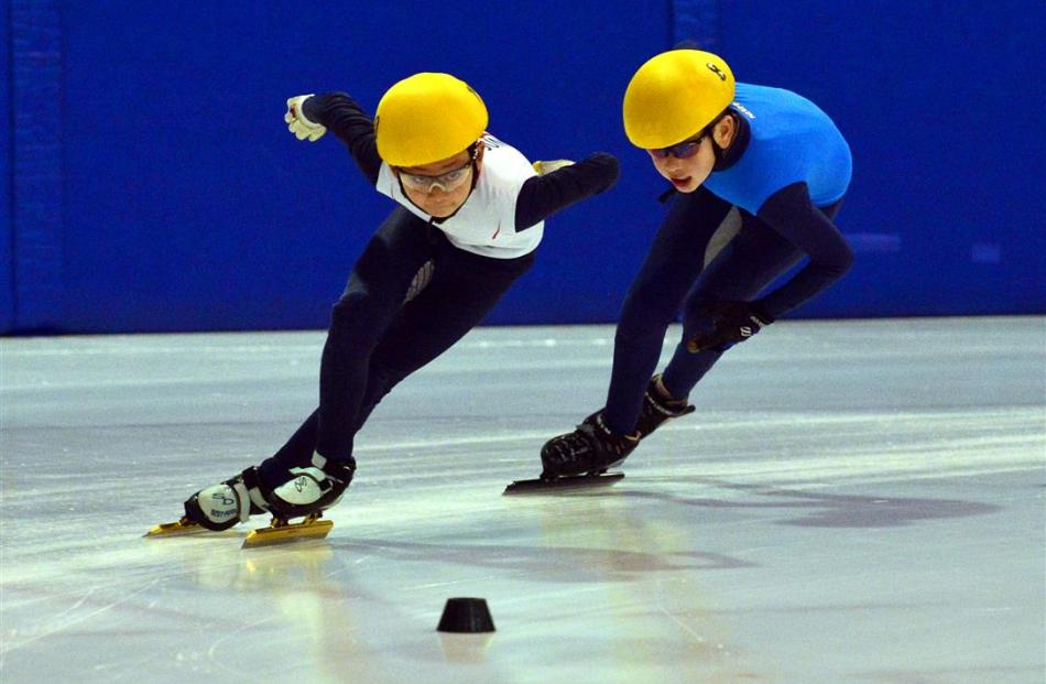 Junior Korean short track ice speed skating team member Eun-Seok Oh (11), of Suwon, skates past...