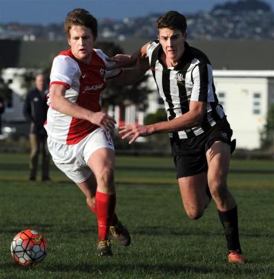 Caversham’s Michael Hogan (left) contests possession with Northern’s Ryan Hawken during a...
