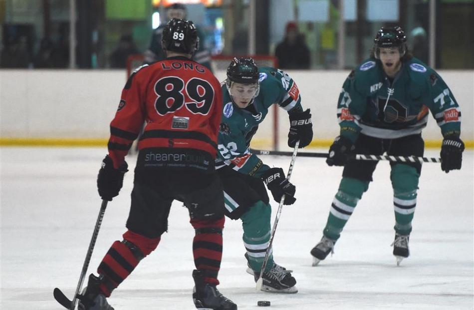 Shaun Harrison, of the Dunedin Thunder, looks to beat Ciaran Long, of the Canterbury Red Devils,...