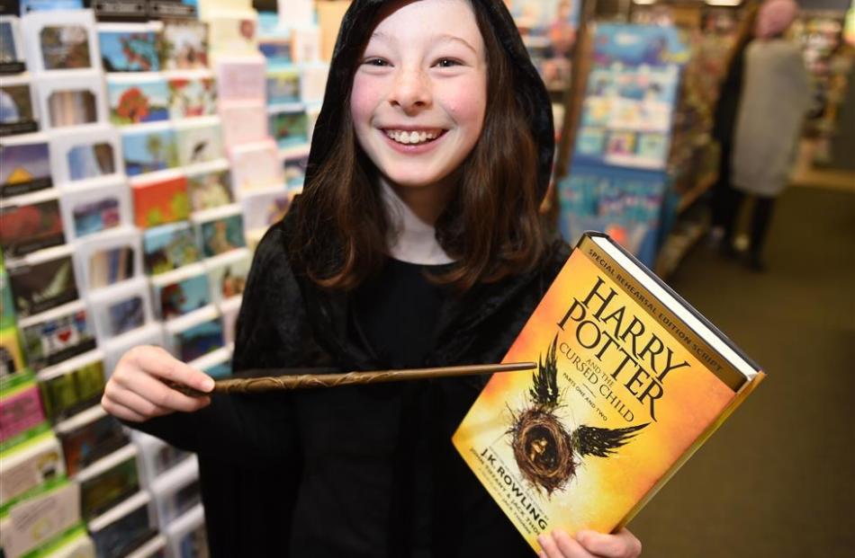 Hannah Hogan, of Broad Bay, points her wand at her copy of Harry Potter and the Cursed Child at...