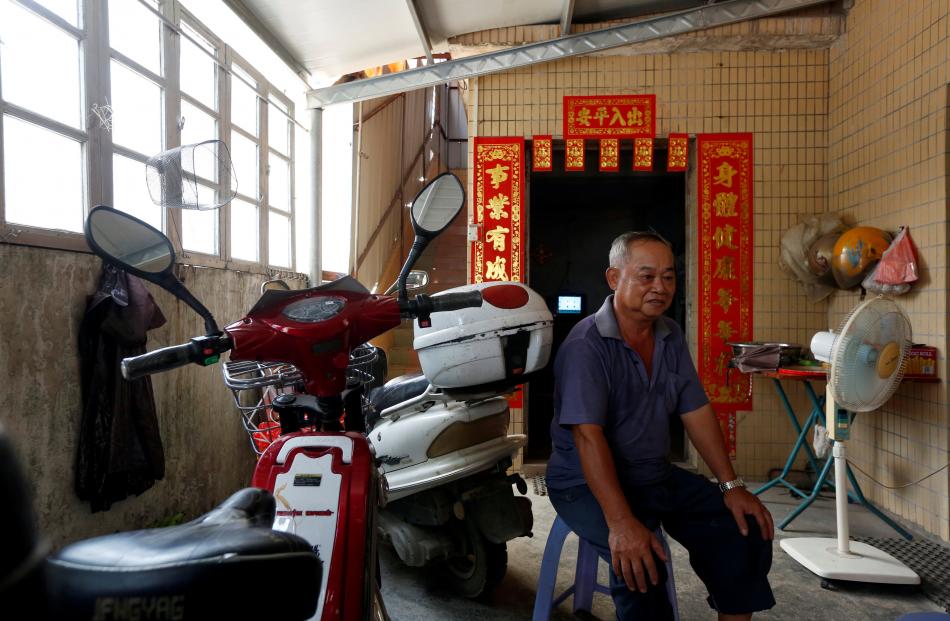 A villager undertakes a health research project on Shazai Island which has with a field studio of...