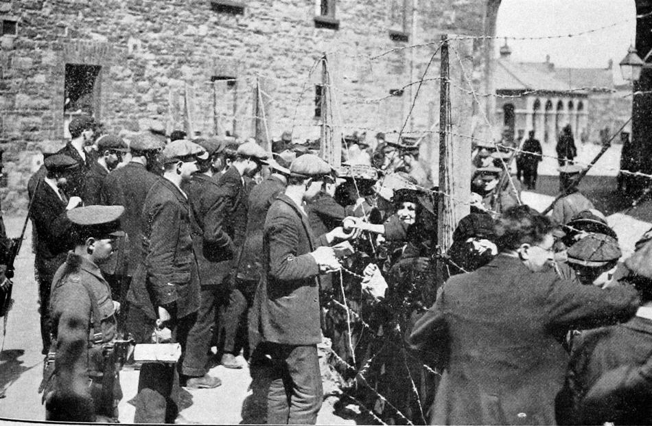 Sinn Feiners who took part in the Easter rebellion in Ireland talking to relatives trough the...